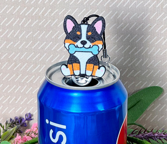 Tab Buddy shaped like a corgi with a blue bone on a soda can against a gray background.