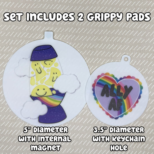 Two circular Groovy Pride-themed Grippy Pads are shown atop a beige background. Text reads, "Set includes 2 Grippy Pads. 5" Diameter with internal magnet. 3.5" diameter with keychain hole."