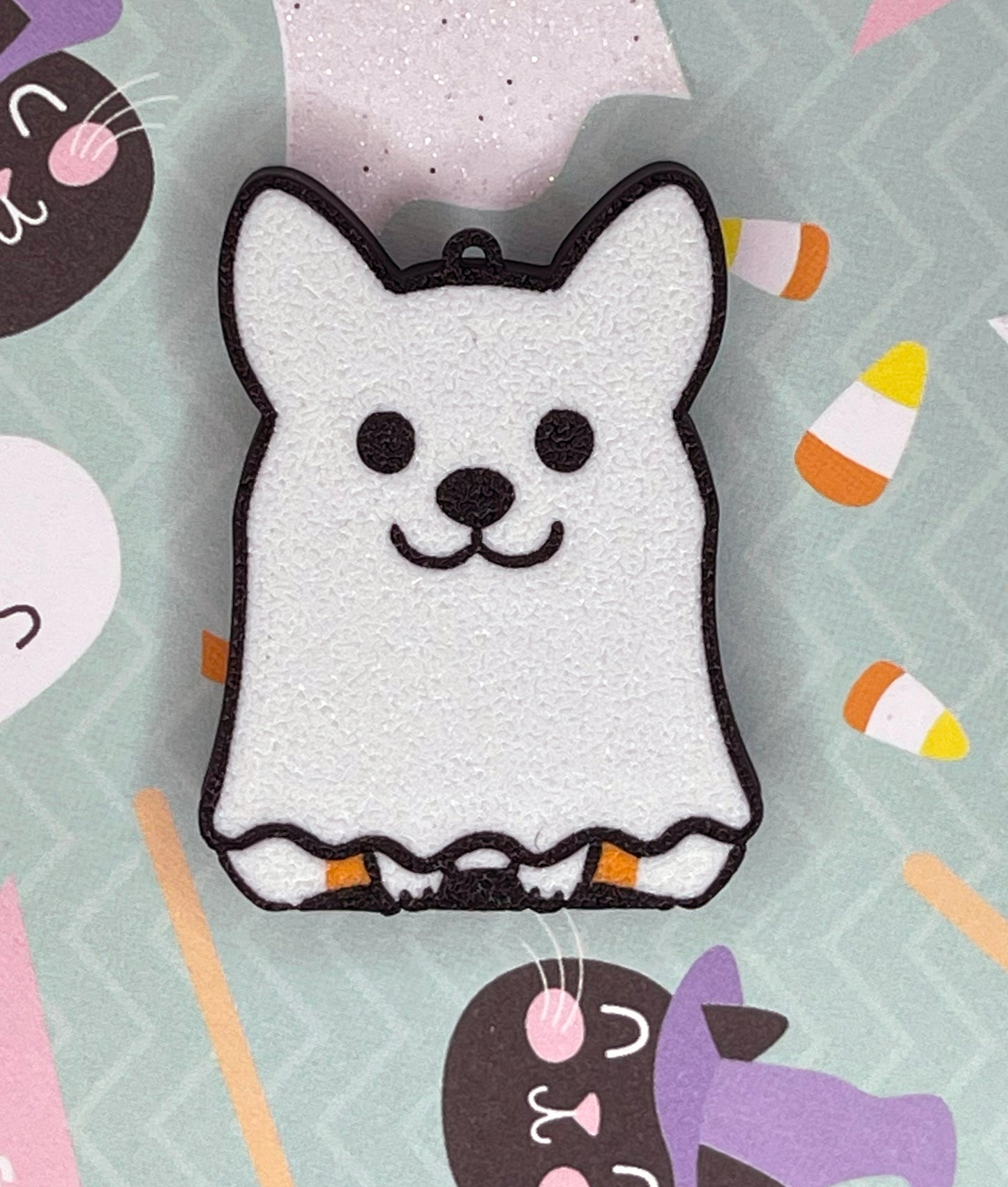 White ghost dog Tab Buddy on a Halloween-themed background with candy corn and pumpkins.