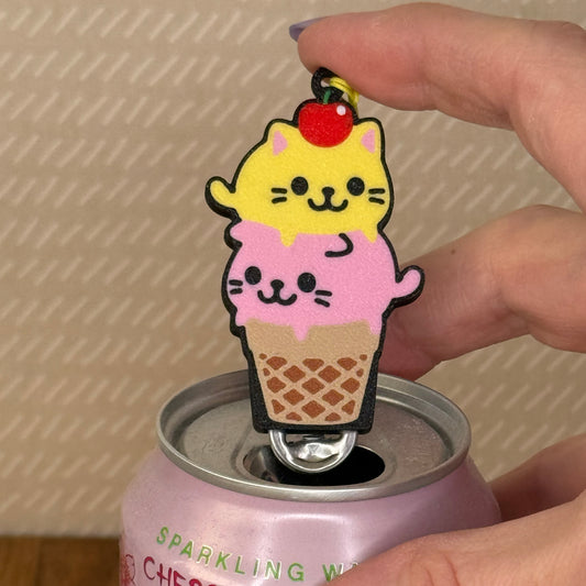 Cute cat-themed ice cream cone Tab Buddy on a can of sparkling water with a blurred background.