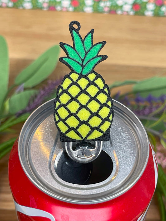 Pineapple-shaped Tab Buddy on a can with a blurred background