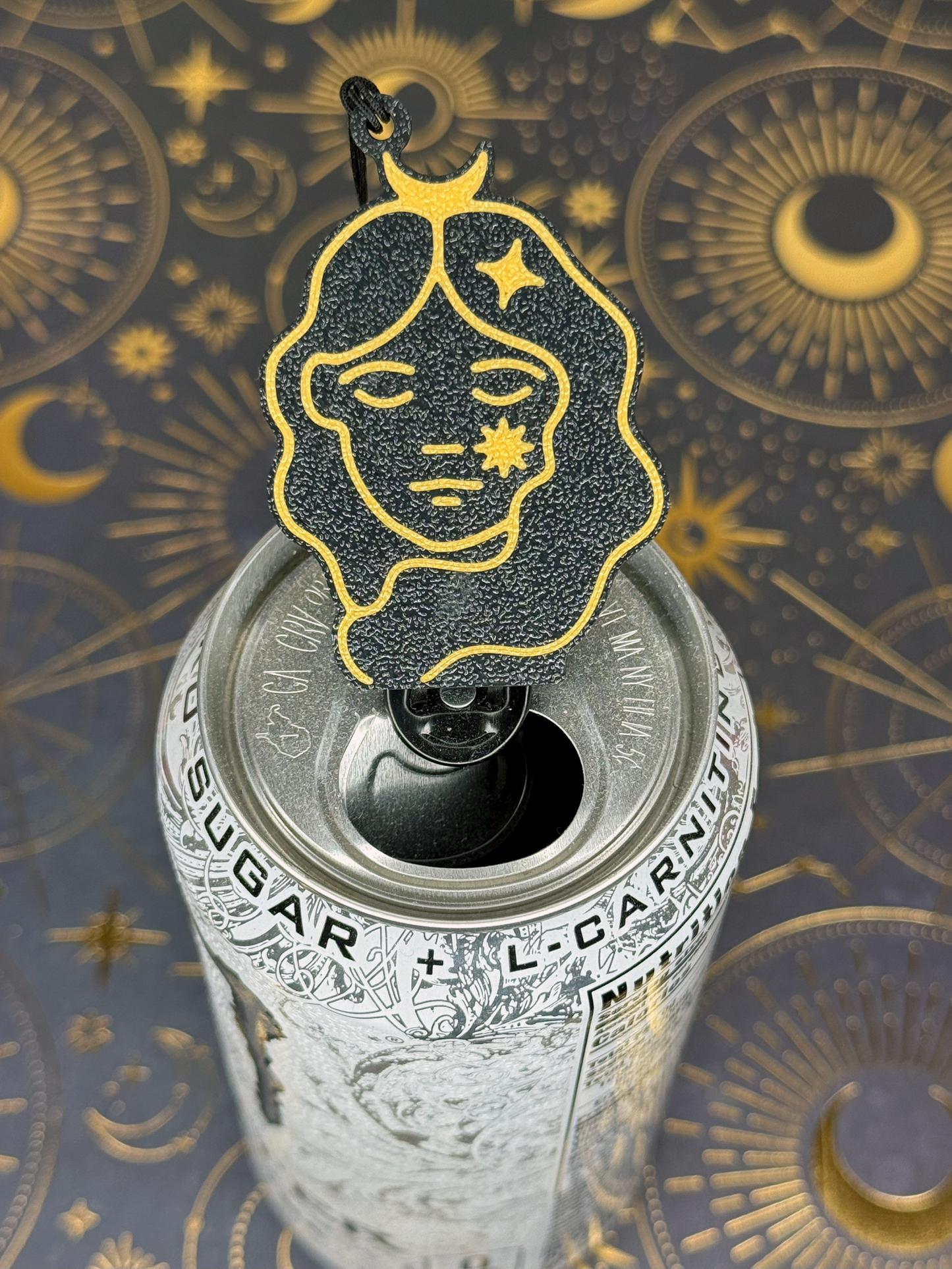 Decorative black and gold Virgo design Tab Buddy with celestial design on a can against an astrological patterned background