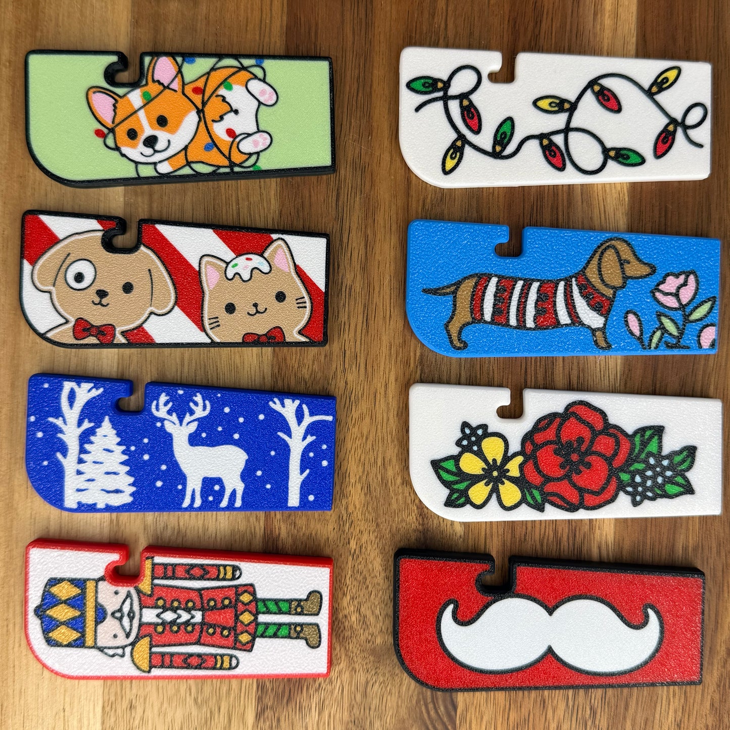 Collection of colorful Tab Buddy XL with various designs on a wooden surface