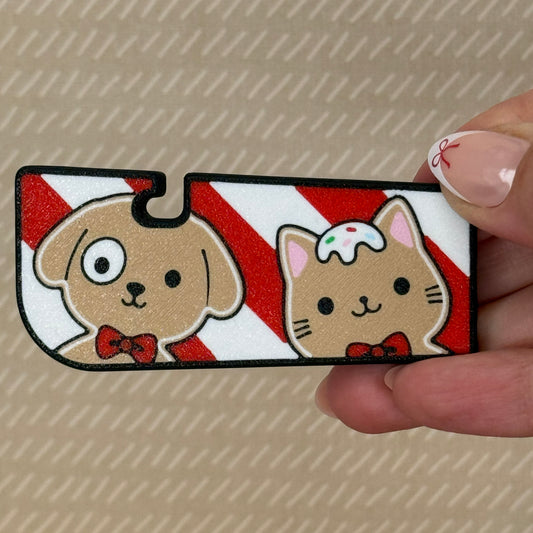 Tab Buddy XL with cartoon gingerbread dog and cat design on a candy cane striped background