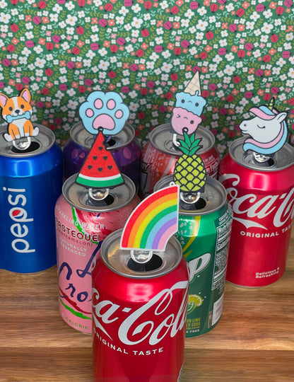 Collection of soda cans with Tab Buddies on a floral background
