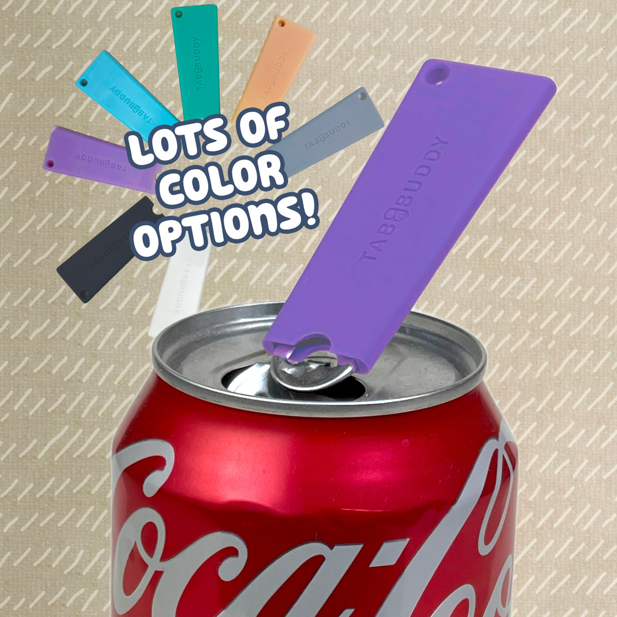 A purple Tab Buddy Classic sits atop an open red Coca-Cola can, with other color options fanned out above and text reading "lots of color options."