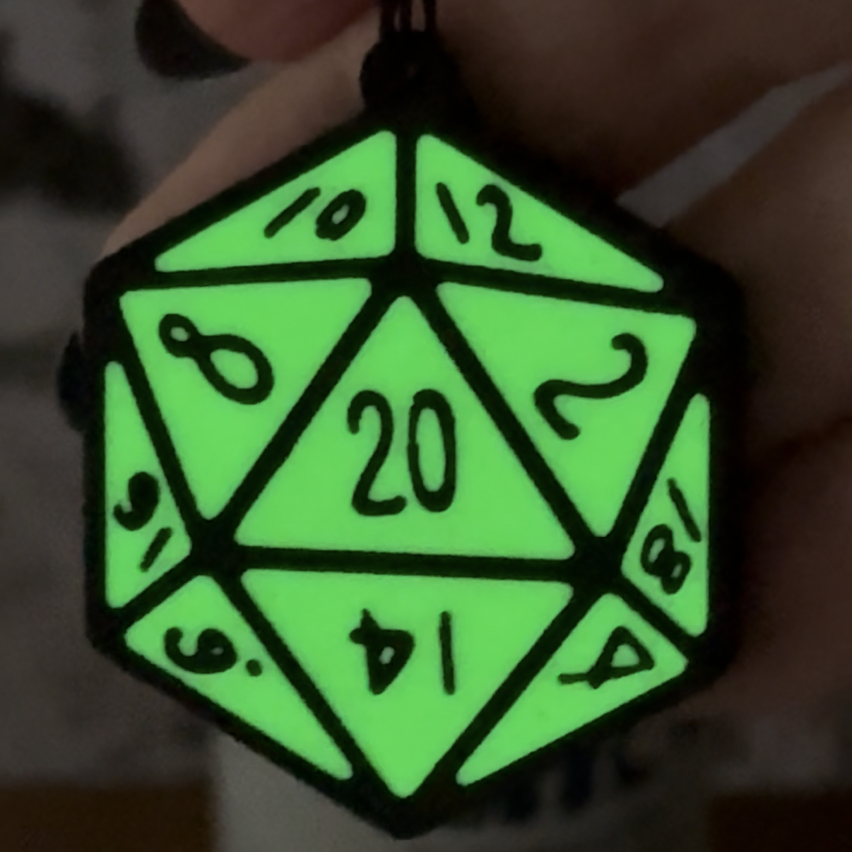 Glowing green D20 die with numbers on a dark background Tab Buddy