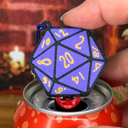 Purple D20 dice Tab Buddy held by a hand on a wooden surface