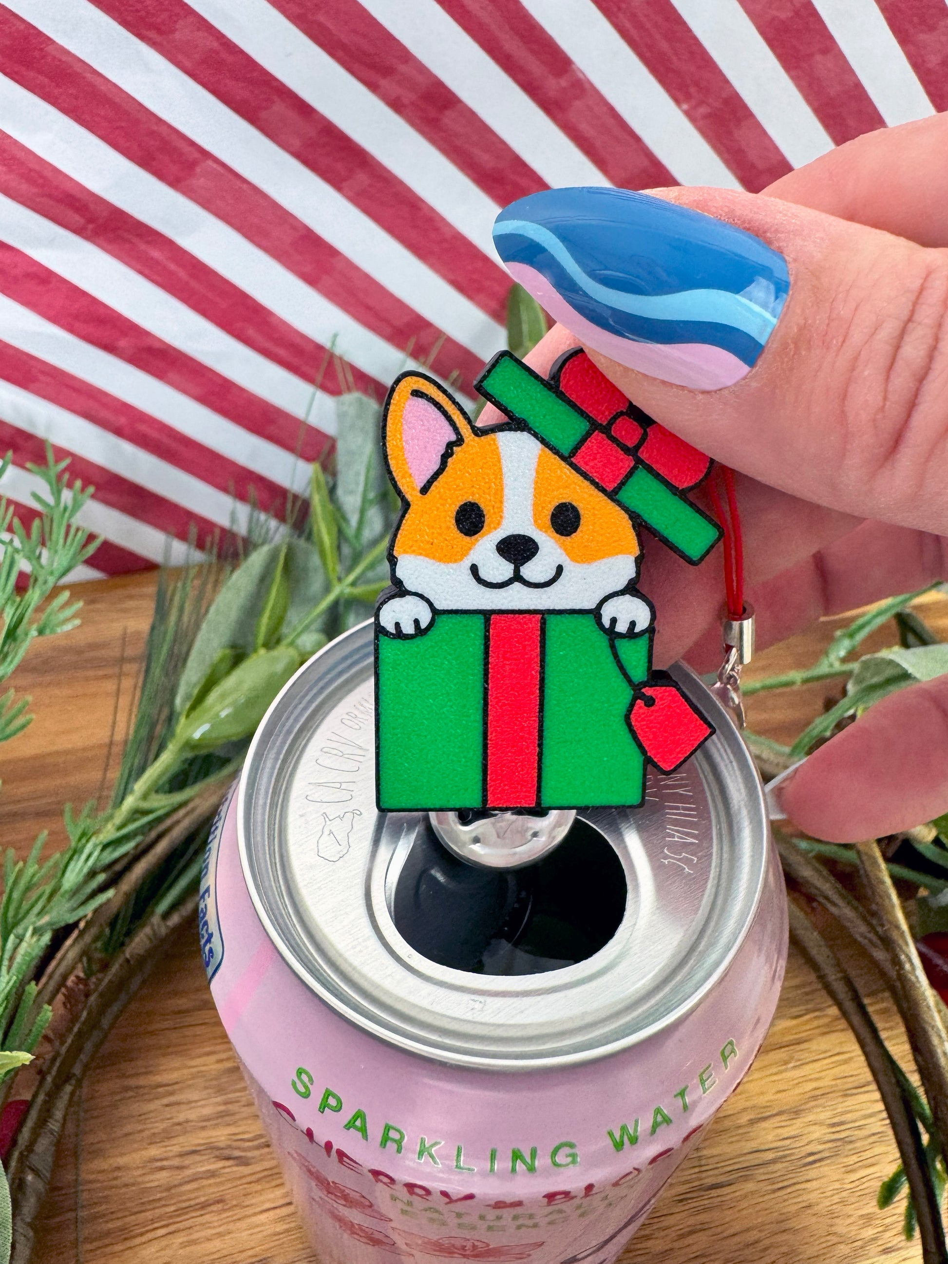 Corgi-shaped Tab Buddy on a can with a striped background