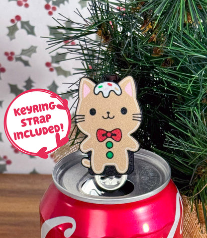 Gingerbread cat Tab Buddy on a soda can with Christmas tree and holly background