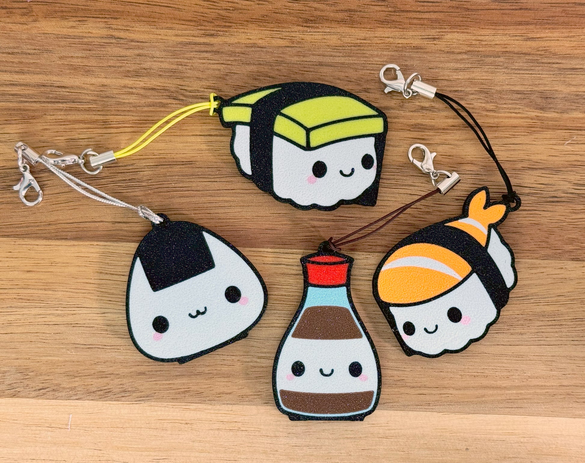 Set of cute sushi-themed Tab Buddies on a wooden surface