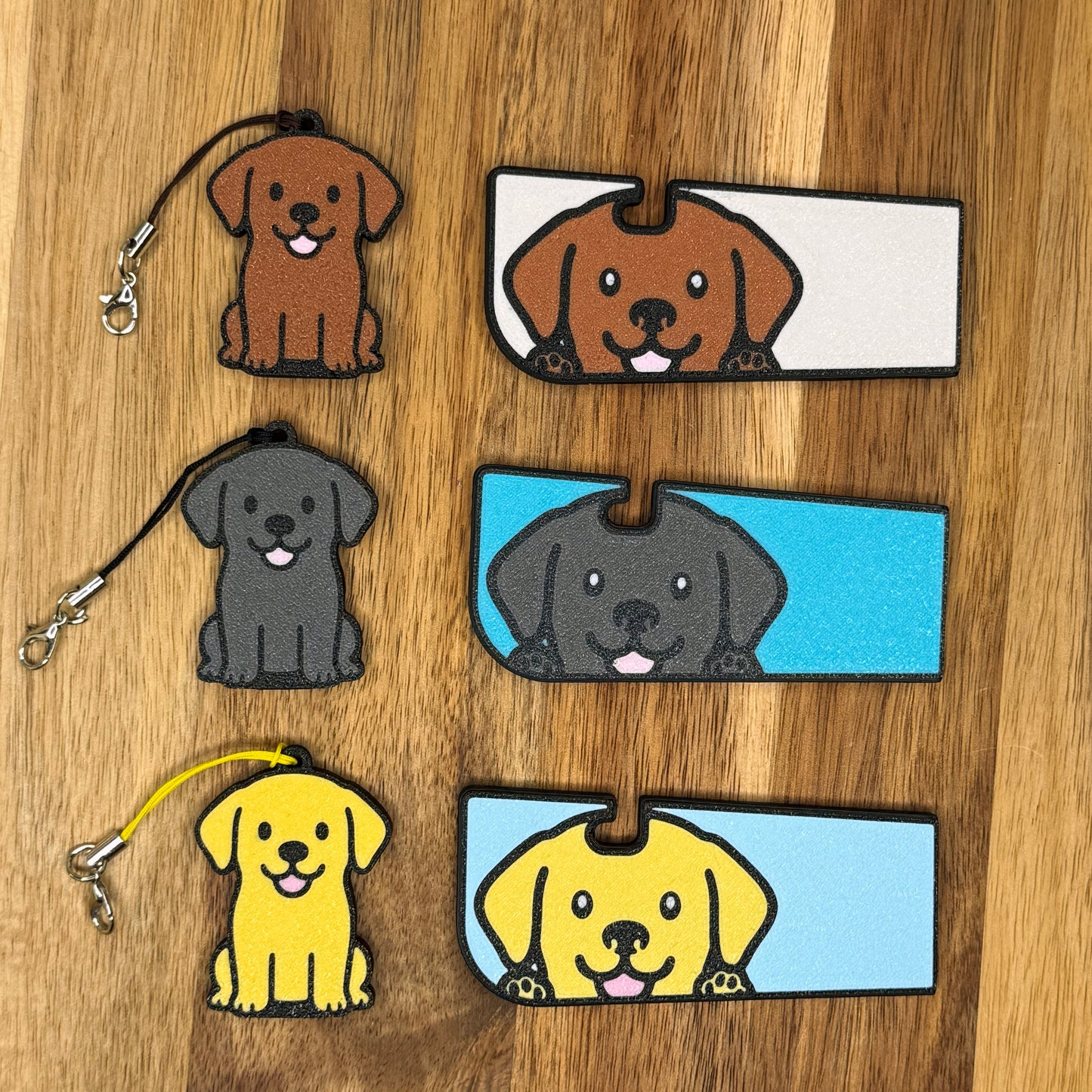 Set of Labrador-themed Soda Tab Buddies and Tab Buddy XLs in Chocolate, Black and Yellow color variations rest on a wooden surface
