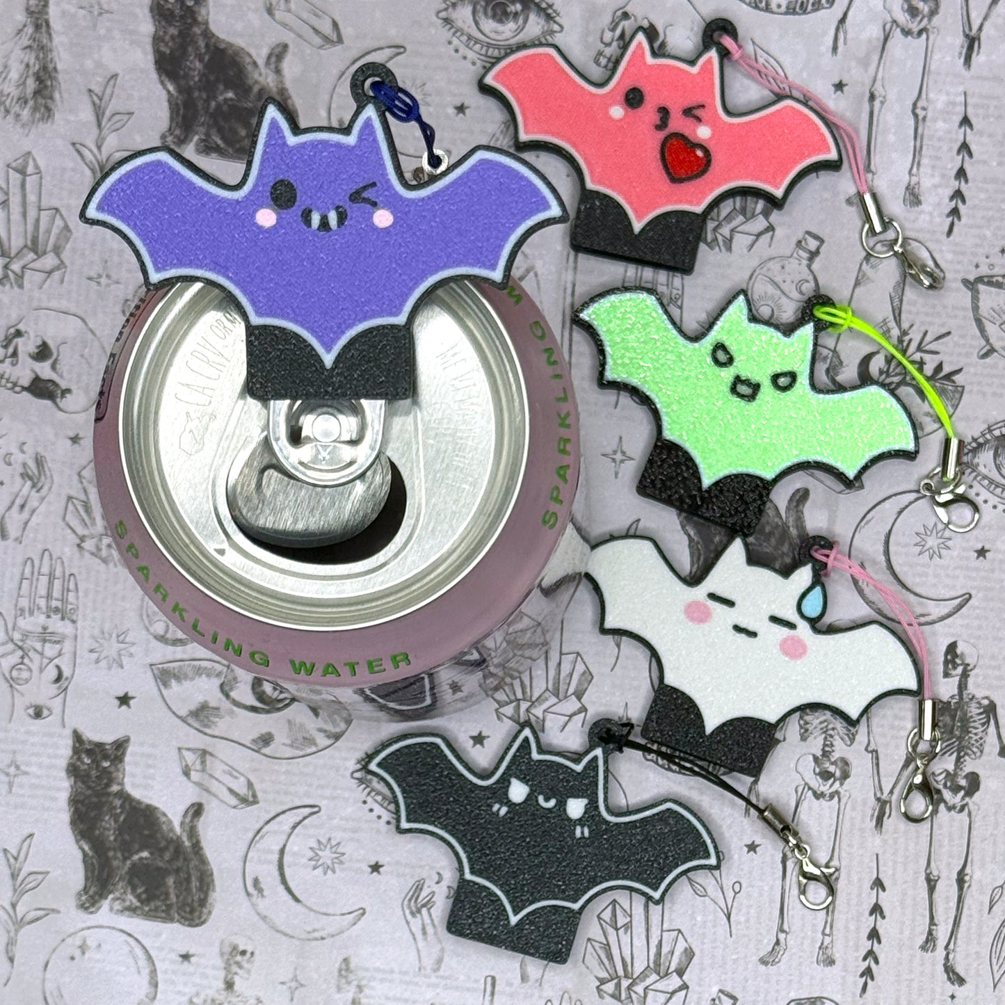 Colorful bat-shaped Tab Buddies on a gray background with illustrations.