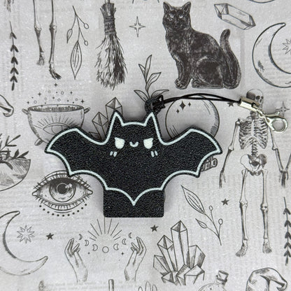 Black bat design Tab Buddy on a gray background with various symbols and objects.