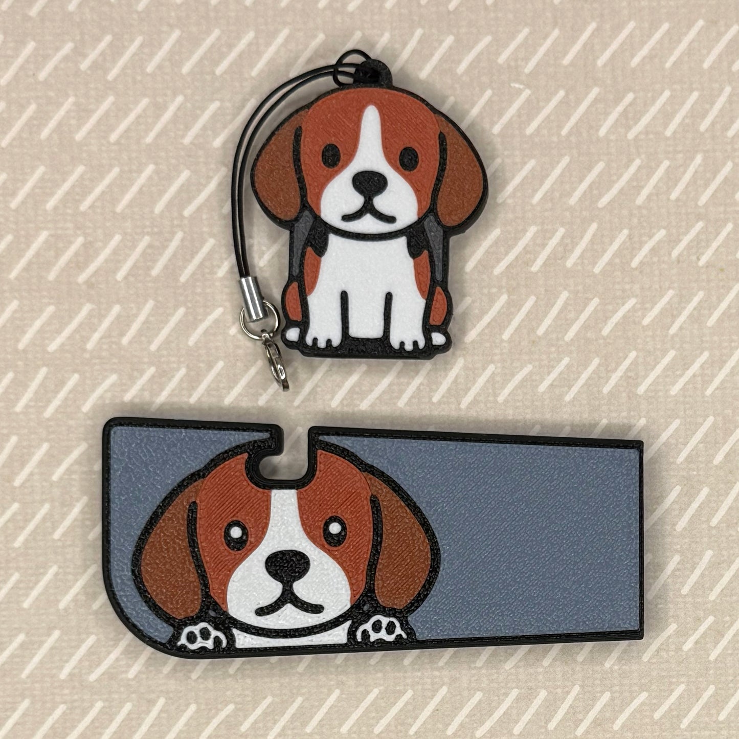 A beagle dog-design Tab Buddy XL and matching soda-sized Tab Buddy rest atop a beige surface.