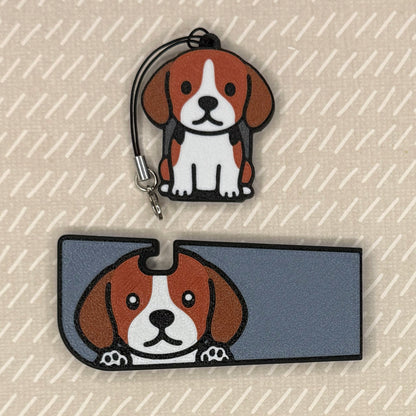 A beagle dog-design Tab Buddy XL and matching soda-sized Tab Buddy rest atop a beige surface.