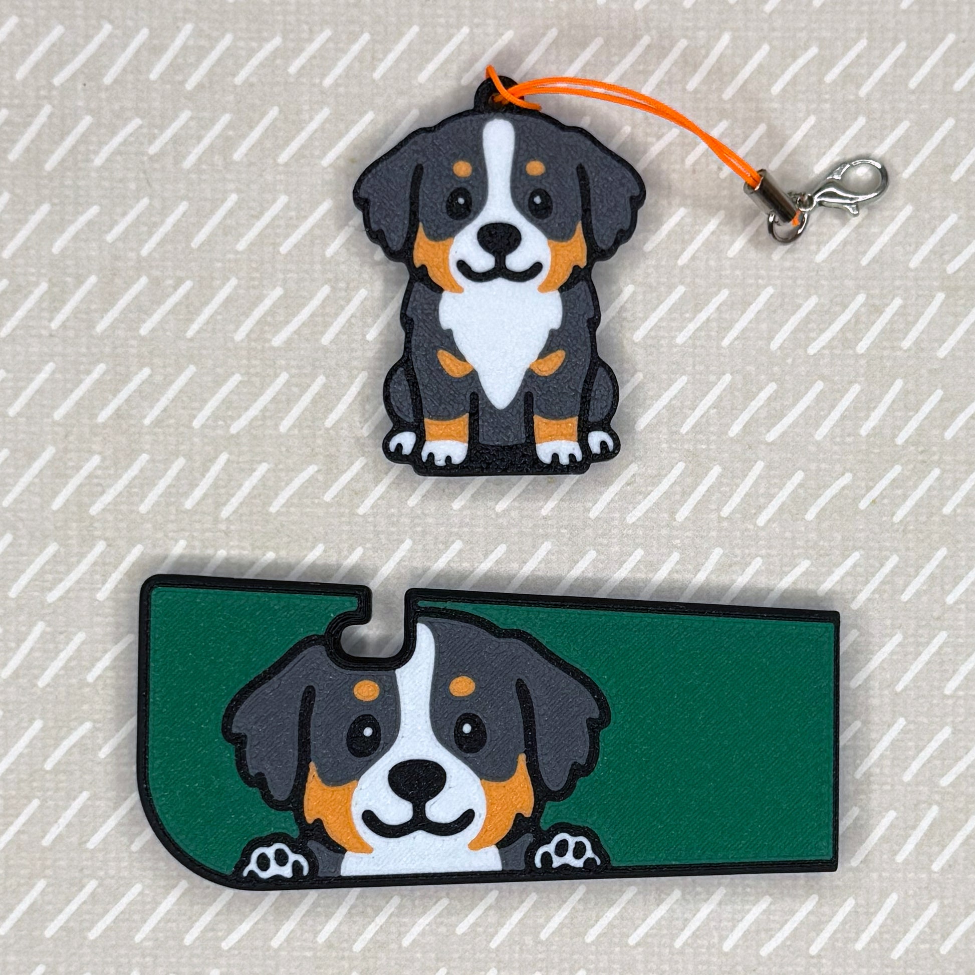 A Bernese Mountain dog-design Tab Buddy XL and matching soda-sized Tab Buddy rest atop a beige surface.