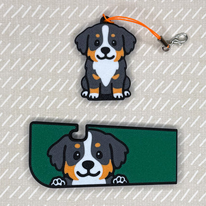 A Bernese Mountain dog-design Tab Buddy XL and matching soda-sized Tab Buddy rest atop a beige surface.
