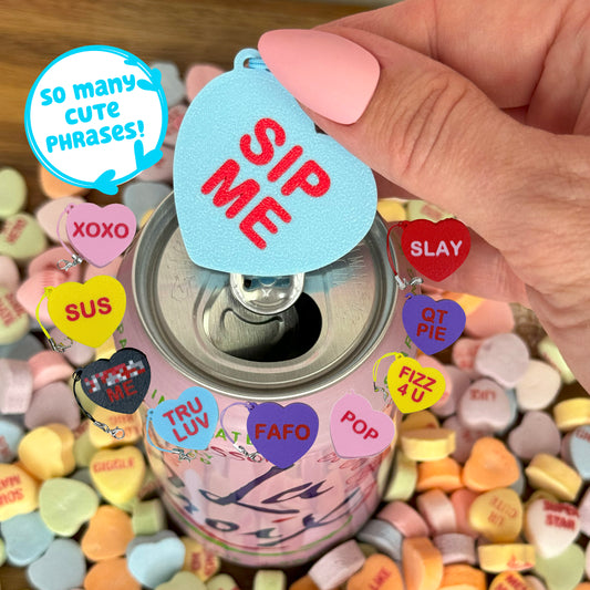 Can with colorful heart-shaped Tab Buddy labeled with phrases, held by a hand. Text indicates "so many cute phrases"