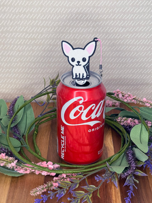 A Cream Chihuahua-inspired Tab Buddy rests atop an open can tab with a beige background and floral accents.