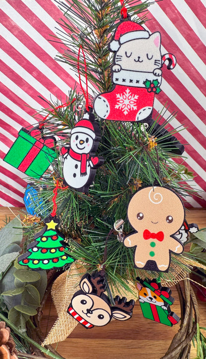Festive Christmas-themed Tab Buddies hang by their straps from a Christmas tree with a striped red and white background