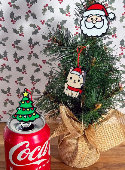 Decorative Christmas tree with Coca-Cola can and christmas themed Tab Buddies on a patterned background