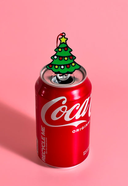 Red Coca-Cola can with a Christmas tree Tab Buddy on a pink background