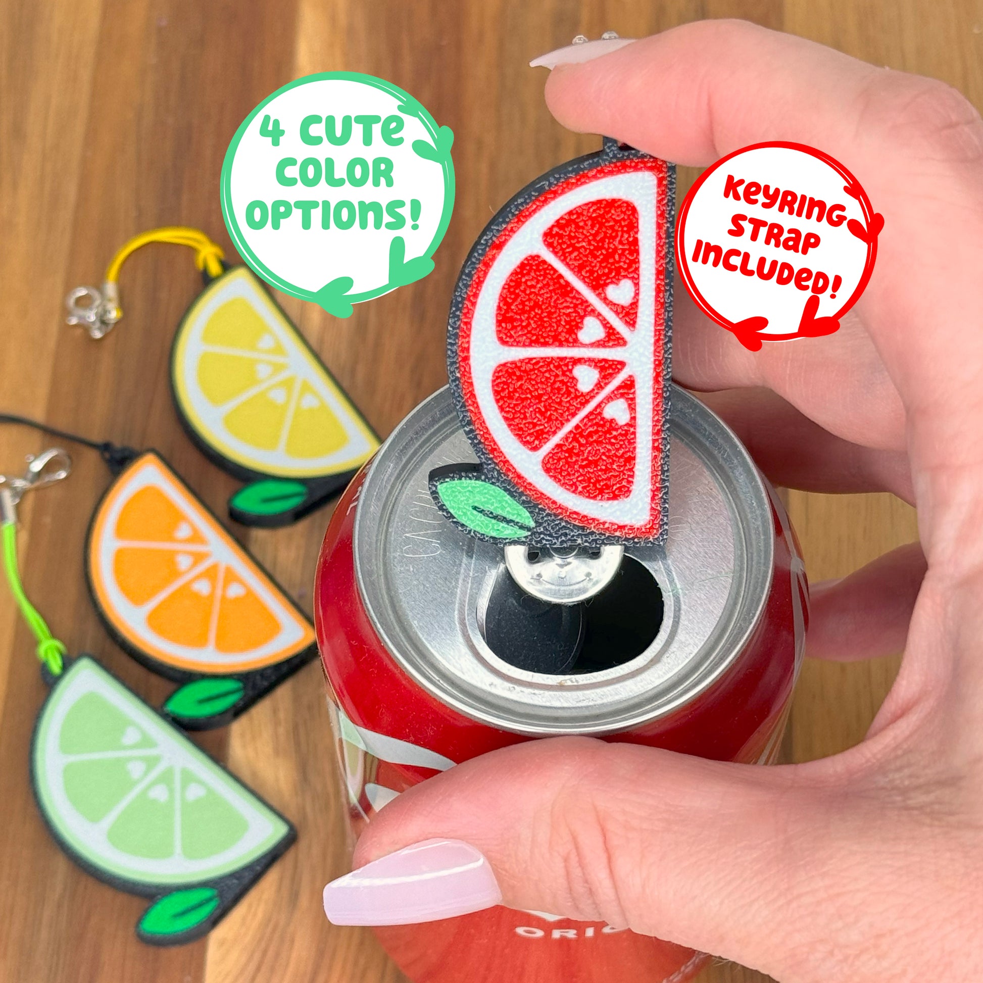 A Tab Buddy with a red grapefruit slice design sits atop a can, surrounded by lemon, orange, and lime design Tab Buddies.