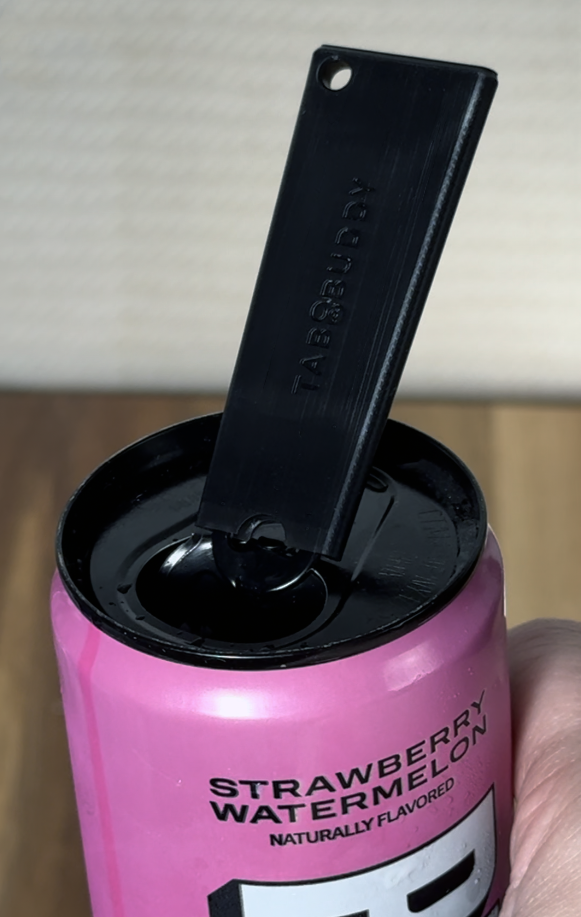 Pink energy drink can with black Tab Buddy Classic on a neutral background.