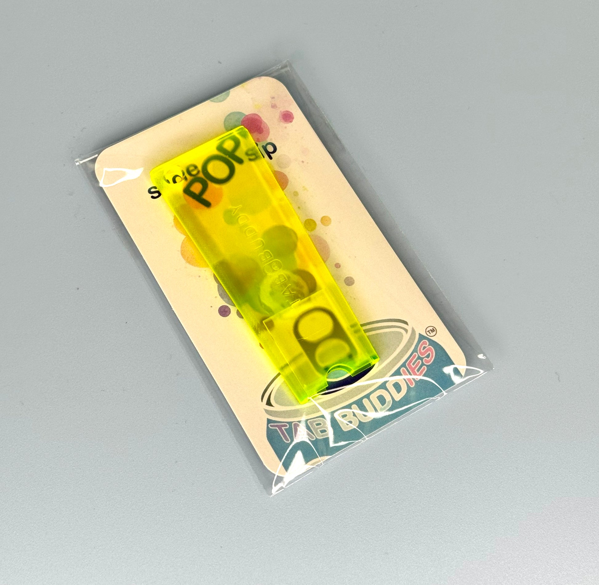 Electric yellow Tab Buddy Classic in packaging with 'Tab Buddies' branding on a gray background