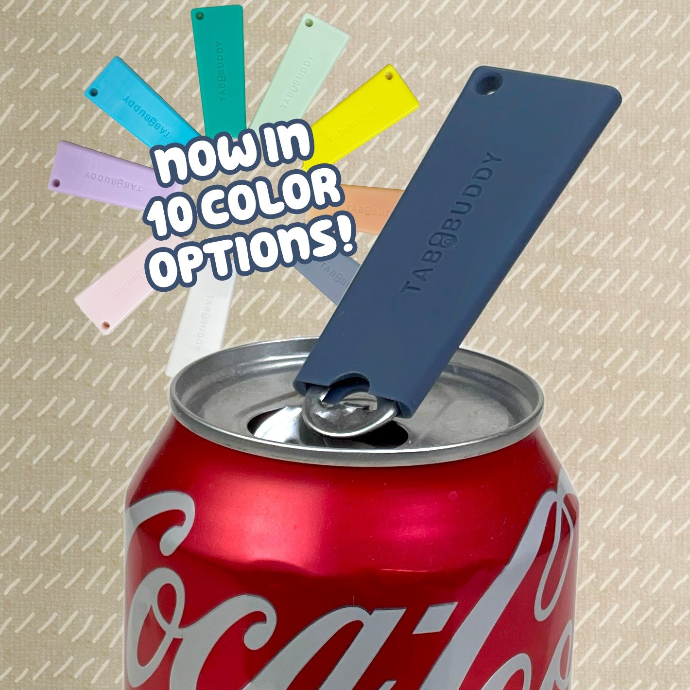 Coca-Cola can with a dark grey Tab Buddy Classic and color swatches on a textured background. Text reads, "now in 10 color options"