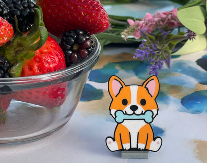 Cartoon dog with a bone Tab Buddy next to a bowl of strawberries and blackberries on a colorful surface.