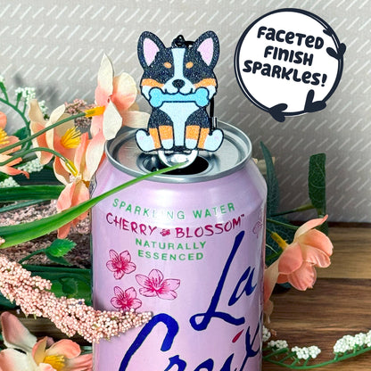 Water can with cherry blossom flavor, featuring a dog-shaped Tab Buddy and decorative elements with text that reads 'faceted finish sparkles!'