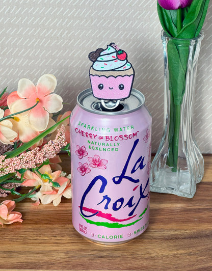 La Croix can with a cupcake Tab Buddy on a wooden surface.
