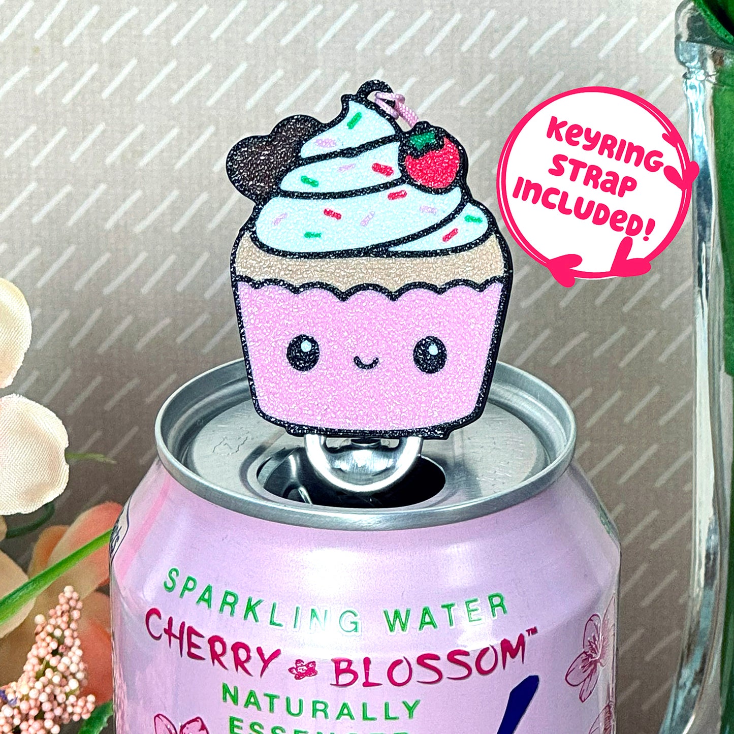 Cute cupcake-shaped Tab Buddy on a can of parkling water with text that reads 'keyring strap included!'