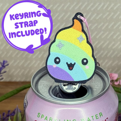 Colorful Tab Buddy keychain shaped like a rainbow-colored poop emoji with silver stars and happy face sits atop a can of sparkling water. Text reads 'Keyring Strap Included!'