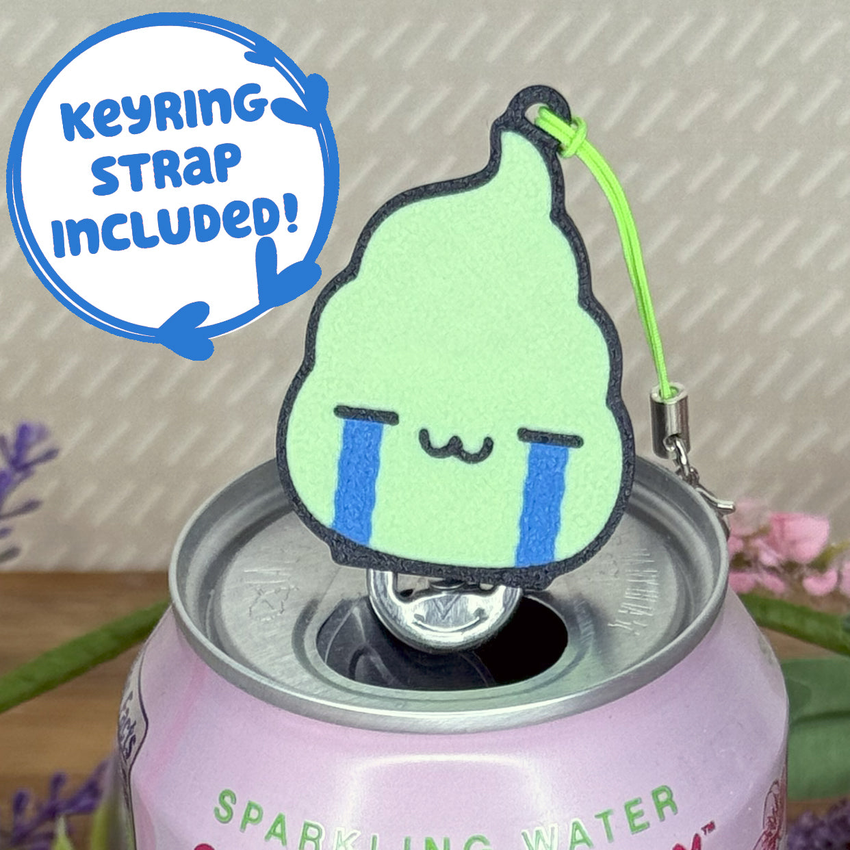 Design of a dollop wasabi with a crying face Tab Buddy on a can of sparkling water with text that reads 'keyring strap included!'