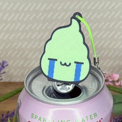 Design of a dollop wasabi with a crying face Tab Buddy attached to a pink sparkling water can.