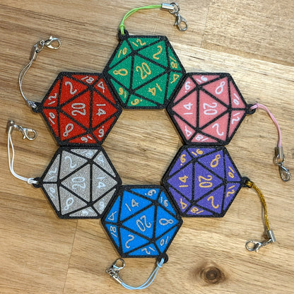 6 color options for D20 Tab Buddies are shown on a wooden surface