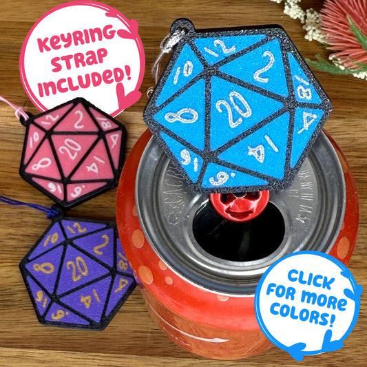 A blue D20 dice Tab Buddy sits atop a red drink can with pink and purple D20 Tab Buddies in background. Text indicates "keyring strap included"