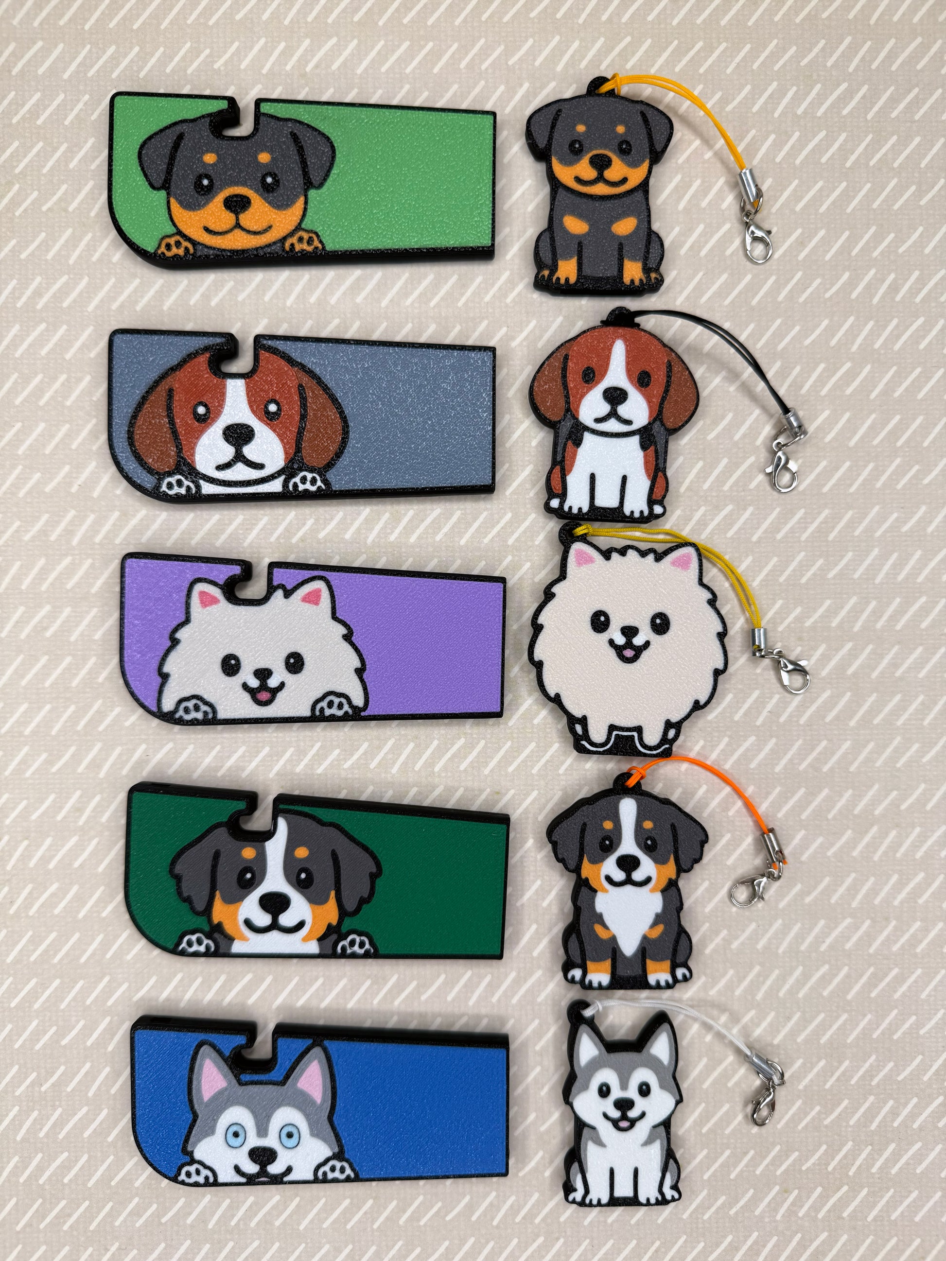A set of 5 dog-themed soda Tab Buddies and matching Tab Buddy XLs rest atop a beige background. The dogs included in this Spring 2026 collection include a Rottweiler, Beagle, Pomeranian, Bernese Mountain Dog and a grey and white Husky.