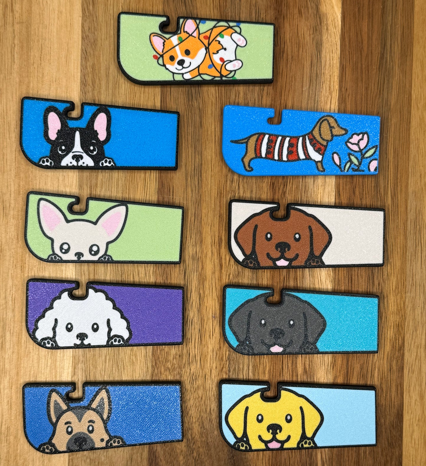 Set of dog-themed Tab Buddy XLs on a wooden surface