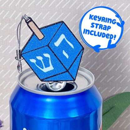 Blue glittery dreidel Tab Buddy on a can with 'Keyring strap included!' text.