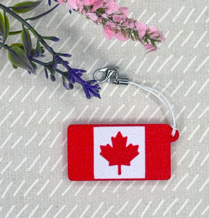 Canadian flag Tab Buddy on a beige background with floral elements