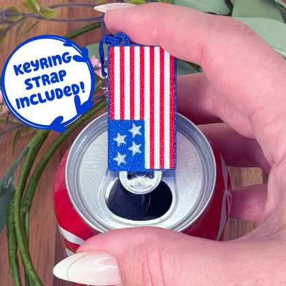 Tab Buddy Keychain with American flag design sits atop a can, with text 'Keyring strap included!'.