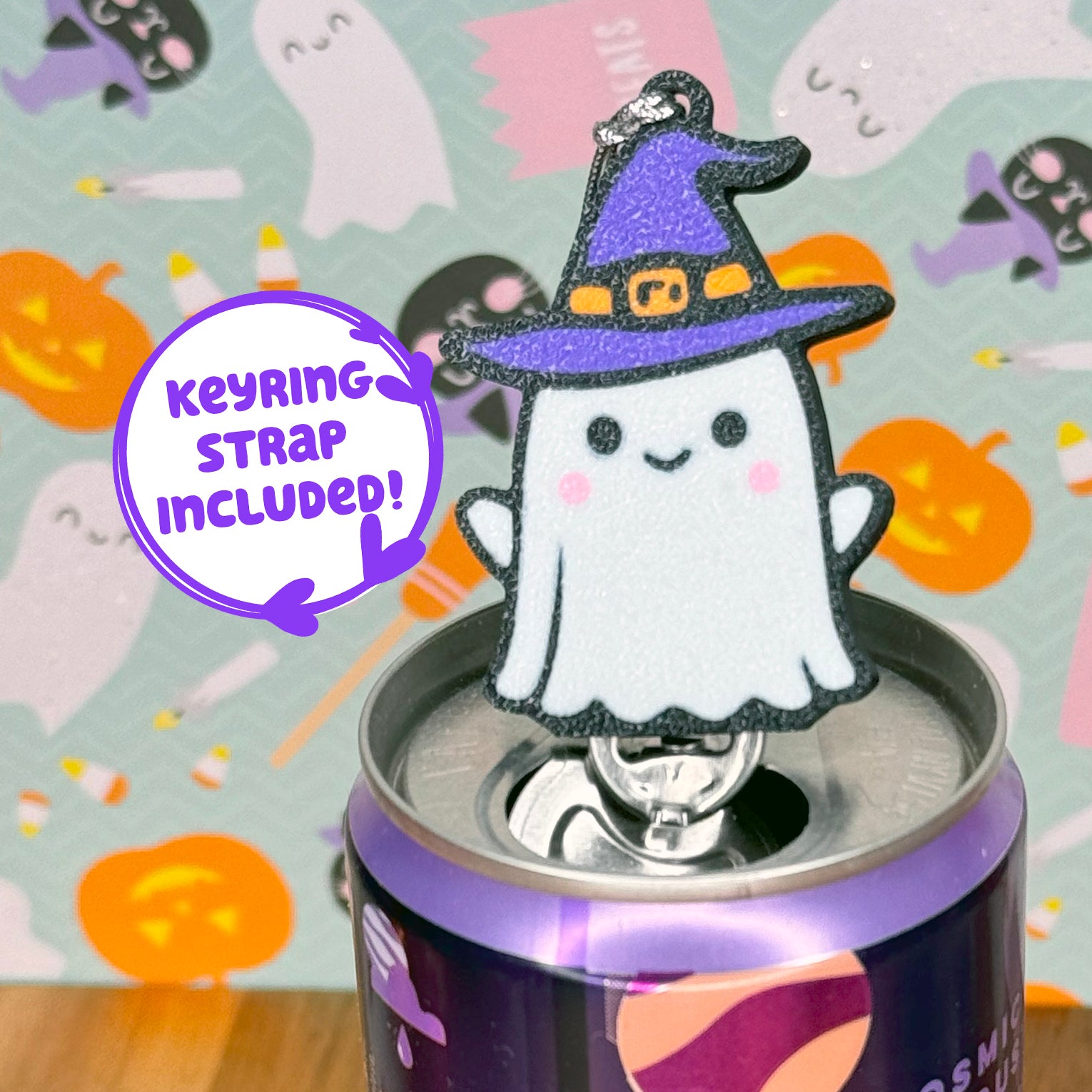 Halloween-themed ghost witch Tab Buddy with keyring strap on a can against a festive background