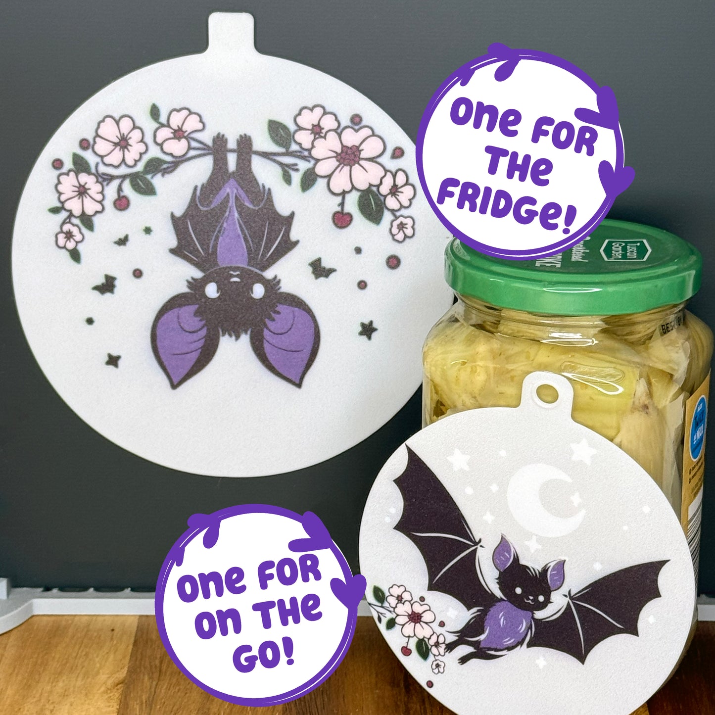 Two silicone Grippy Pads with bat designs on a jar and a black surface, with text 'One for the Fridge!' and 'One for On the Go!'.