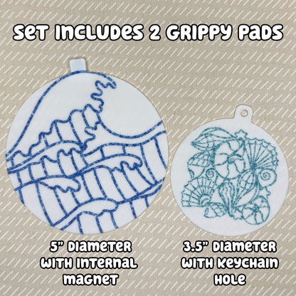 Two circular ocean and shells-themed Grippy Pads are shown atop a beige background. Text reads, "Set includes 2 Grippy Pads. 5" Diameter with internal magnet. 3.5" diameter with keychain hole."