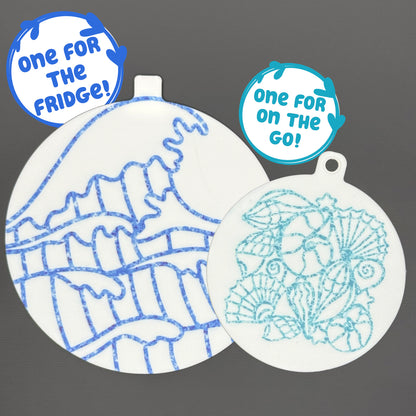 Two circular ocean and shells-themed Grippy pads are shown against a grey background. Text bubbles read, "One for the fridge," and "One for on the go!"