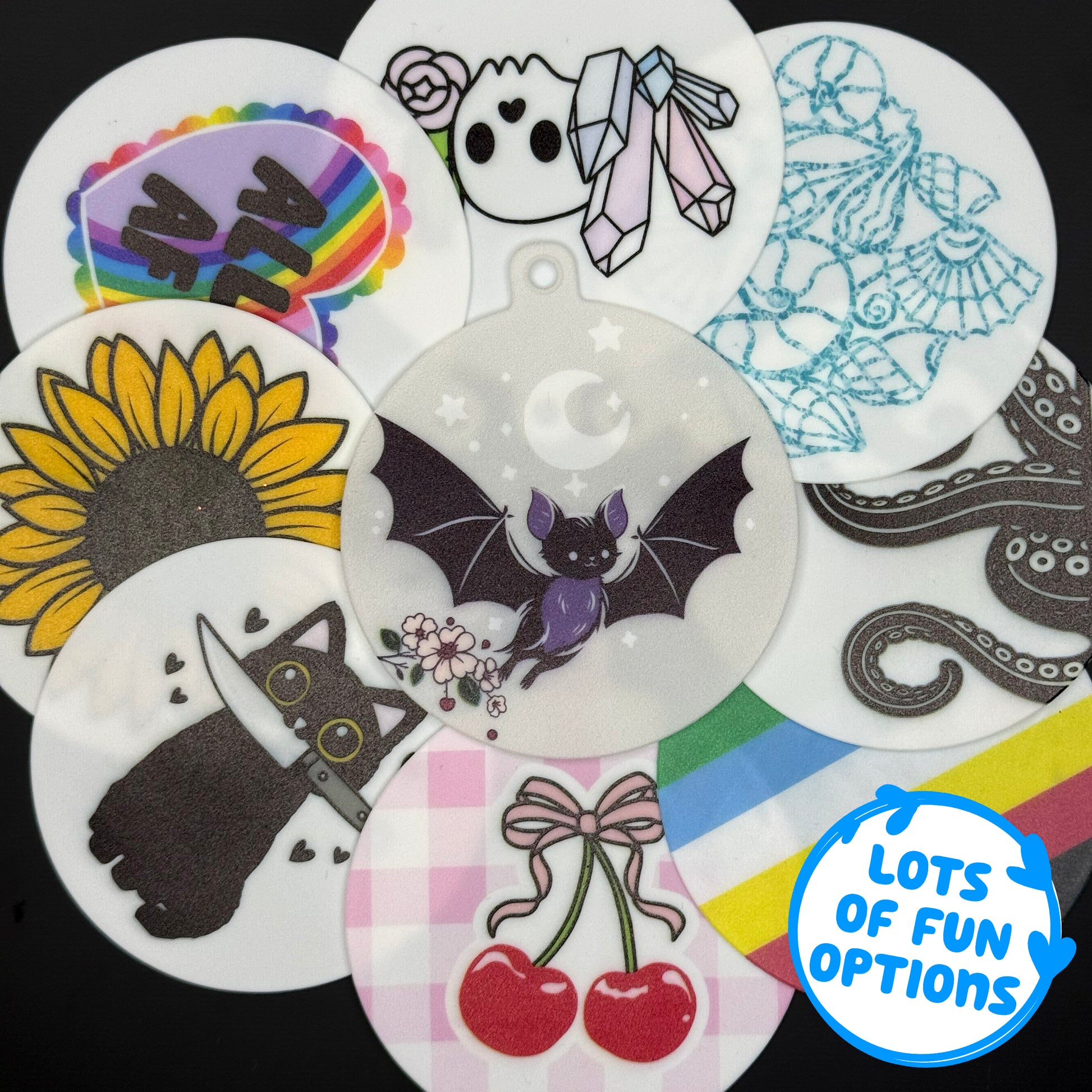 A collection of 9 Grippy Pad designs available in the Tab Buddies Spring 2026 collection are shown against a black background. A text bubble reads, "Lots of fun options!"